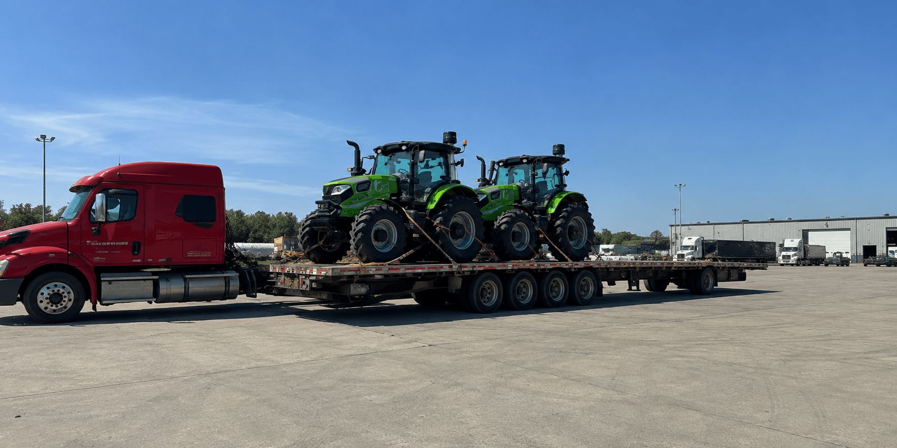 High-horsepower tractor loaded on heavy haul trailer at sunset