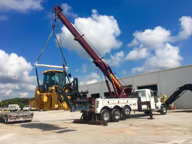 Crane Lifting Heavy Construction Equipment